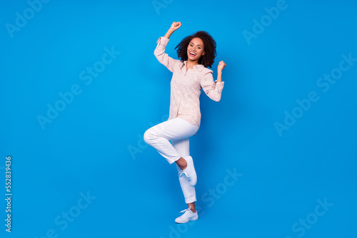 Fototapeta Naklejka Na Ścianę i Meble -  Full length photo of delighted positive person raise fists luck attainment isolated on blue color background