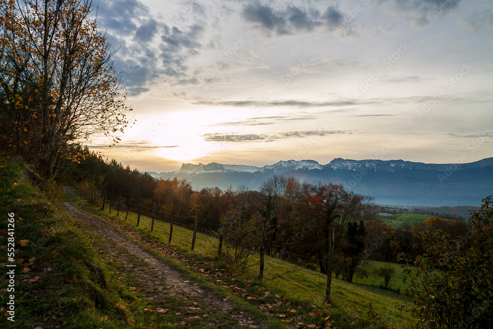 Uriage les Bains, Isere, Rhone-Alpes, France, 27 11 2022 sun setting over snowy mountains, silhouette of trees, rural landscape, countryside scenery