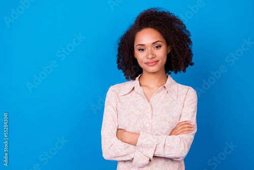 Portrait of gorgeous successful person crossed arms empty space isolated on blue color background