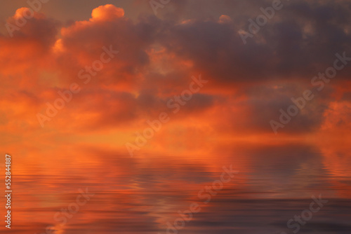 sea water surface with red clouds at sunset