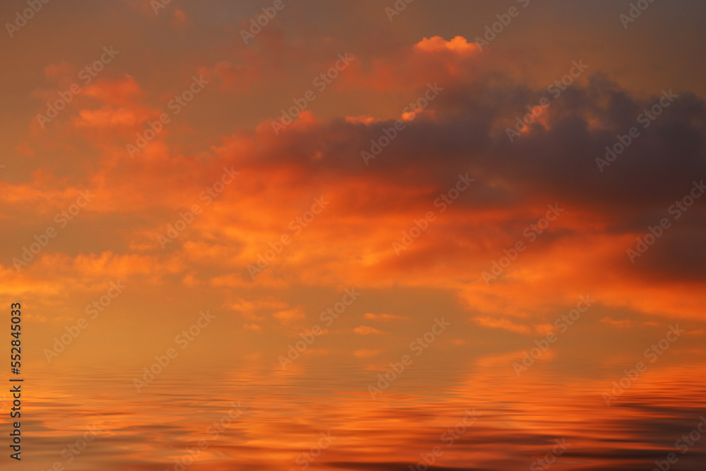 sea water surface with pink clouds at sunset. into a horizontal frame
