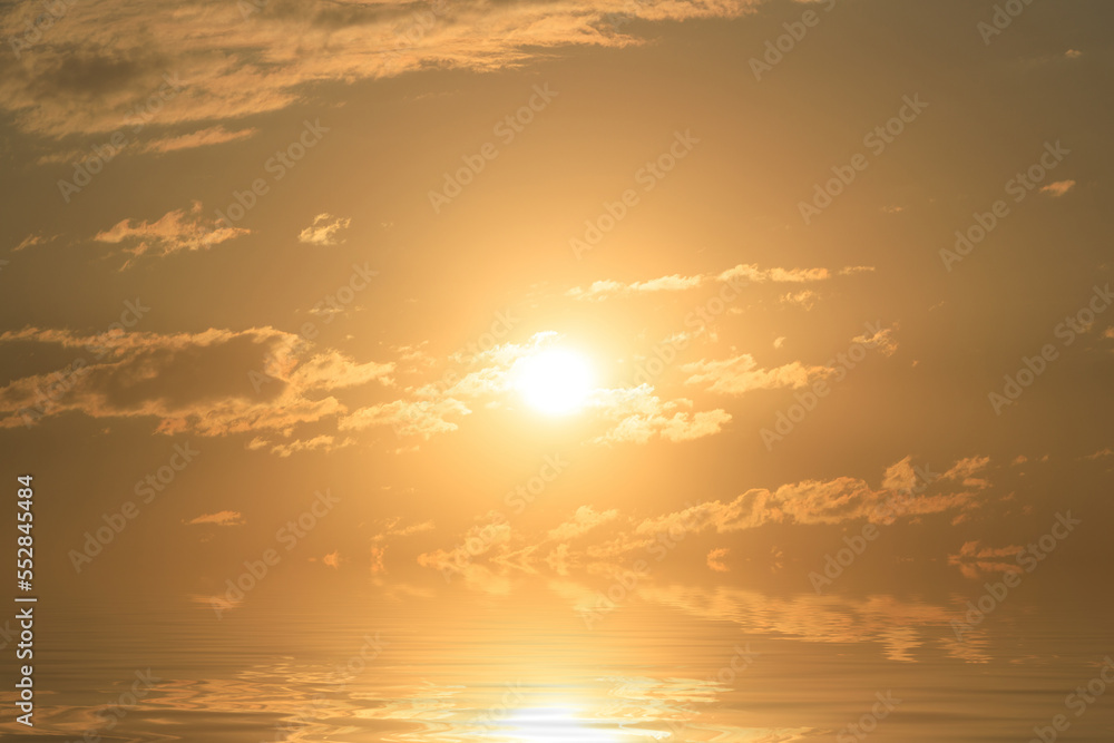 sea water surface with sun and clouds at sunset