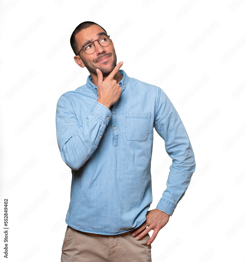 Surprised young man making a gesture of doubt Surprised young man making a gesture of doubt