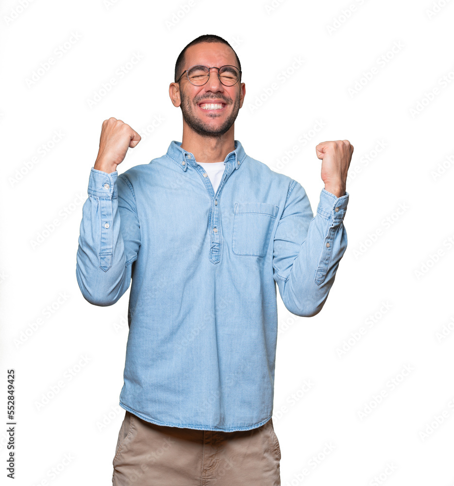 Competitive young man making a gesture of celebration Competitive young man making a gesture of celebration