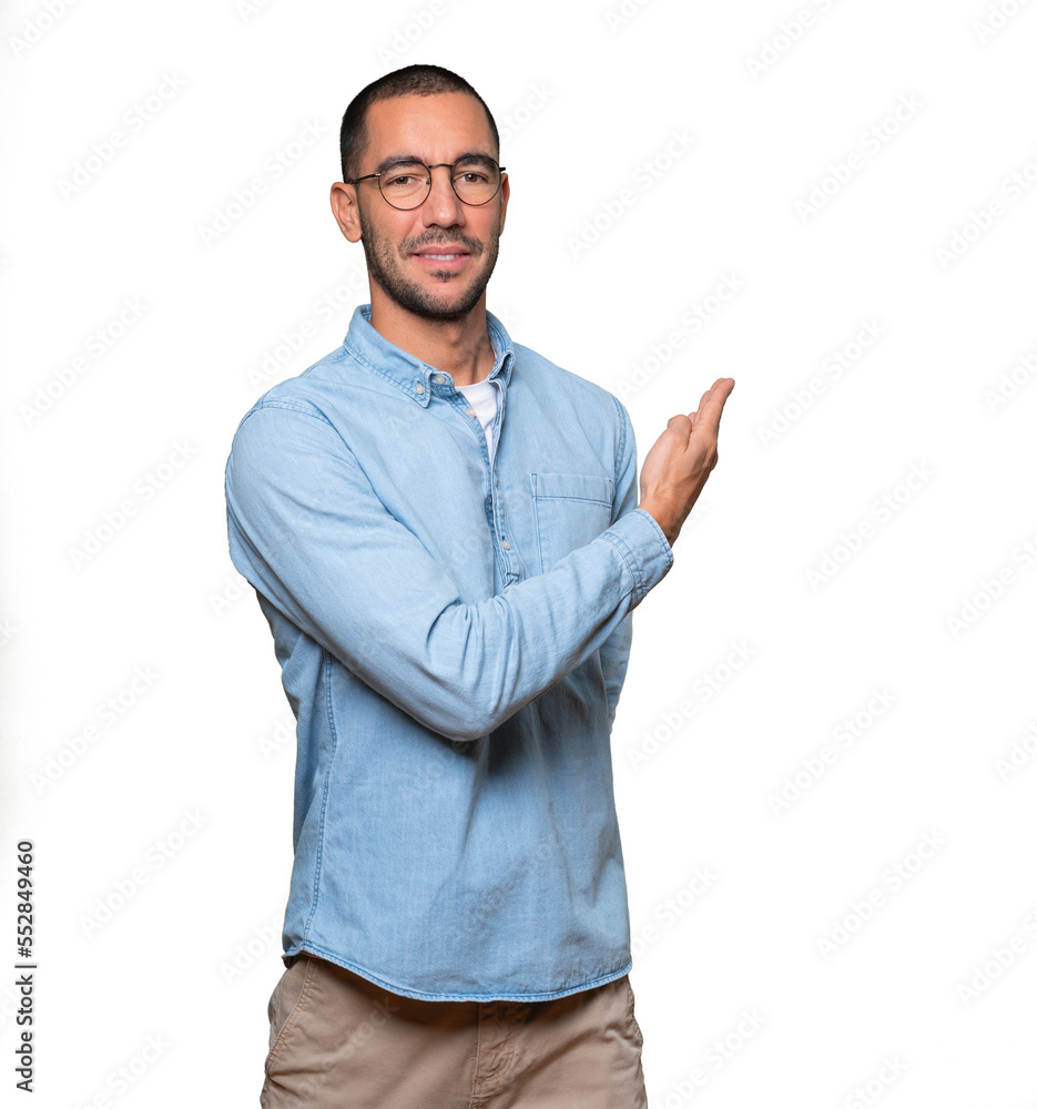 Friendly young man making a gesture of welcome Friendly young man making a gesture of welcome