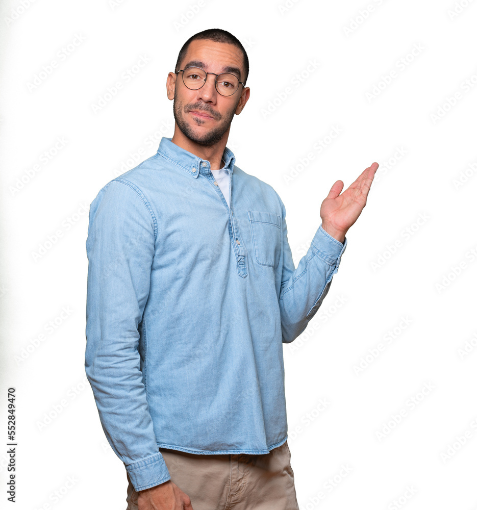 Amazed young man making a gesture of welcome Amazed young man making a gesture of welcome