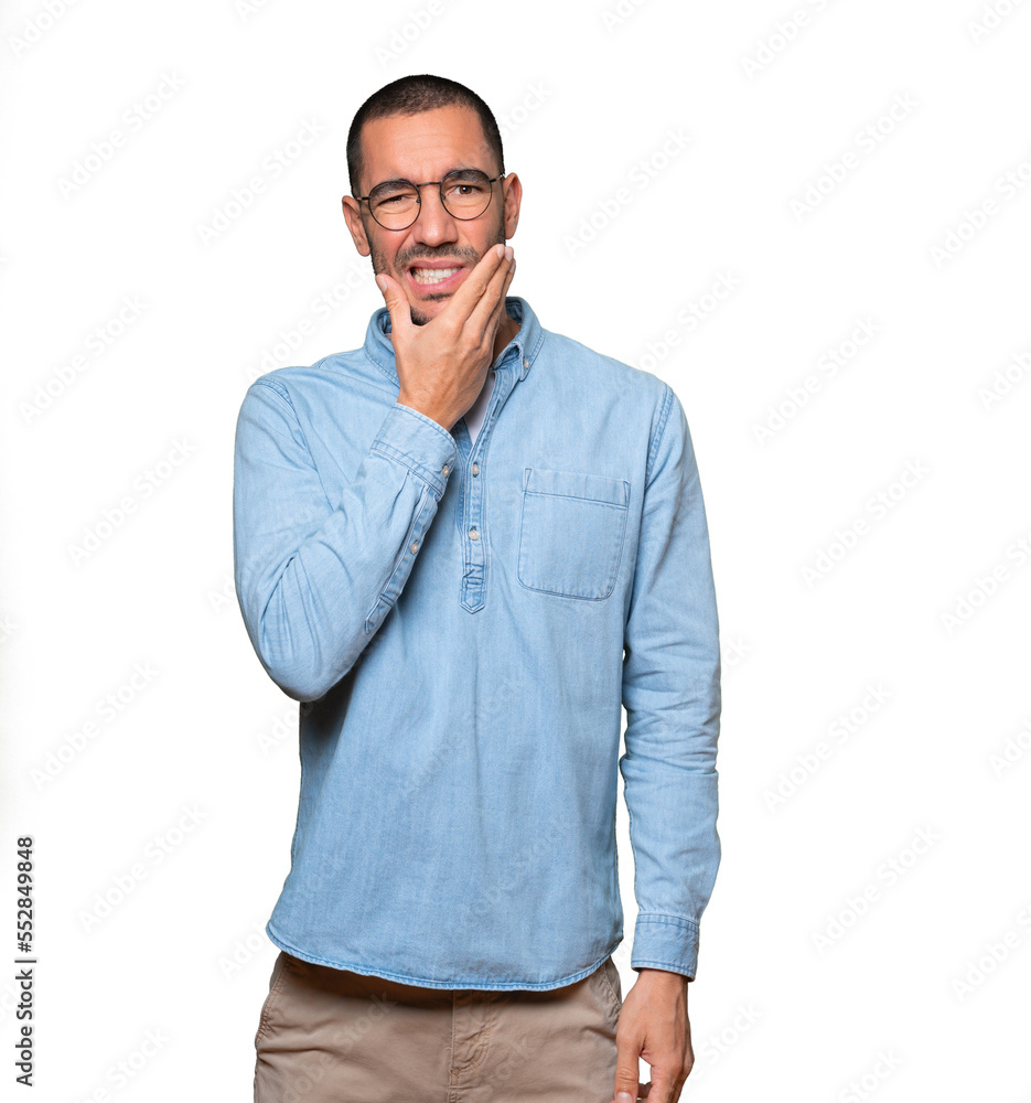 Concerned young man with a toothache gesture Concerned young man with a toothache gesture