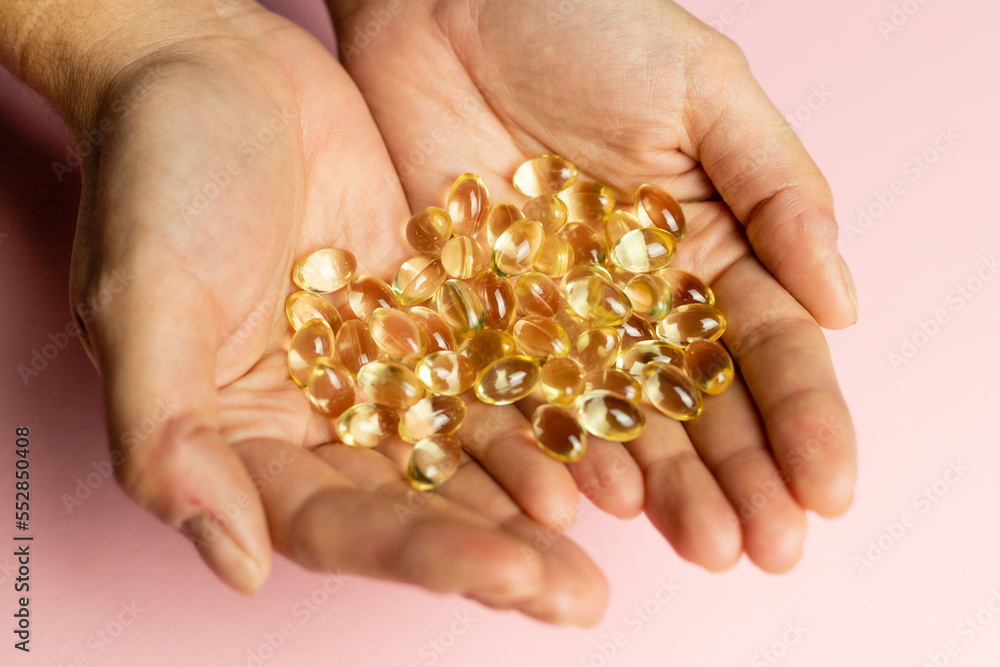 D3 K2 capsules on the hands. Strengthening immunity and care for health. D3 K2 capsules on the hands. Strengthening immunity and care for health.