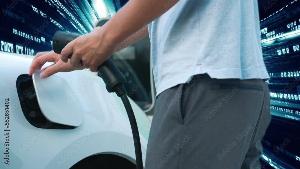 Progressive man charge electric car with power cable plug from charging ...
