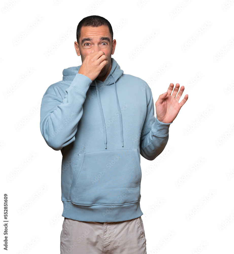 Concerned young man with a gesture of disgust Concerned young man with a gesture of disgust