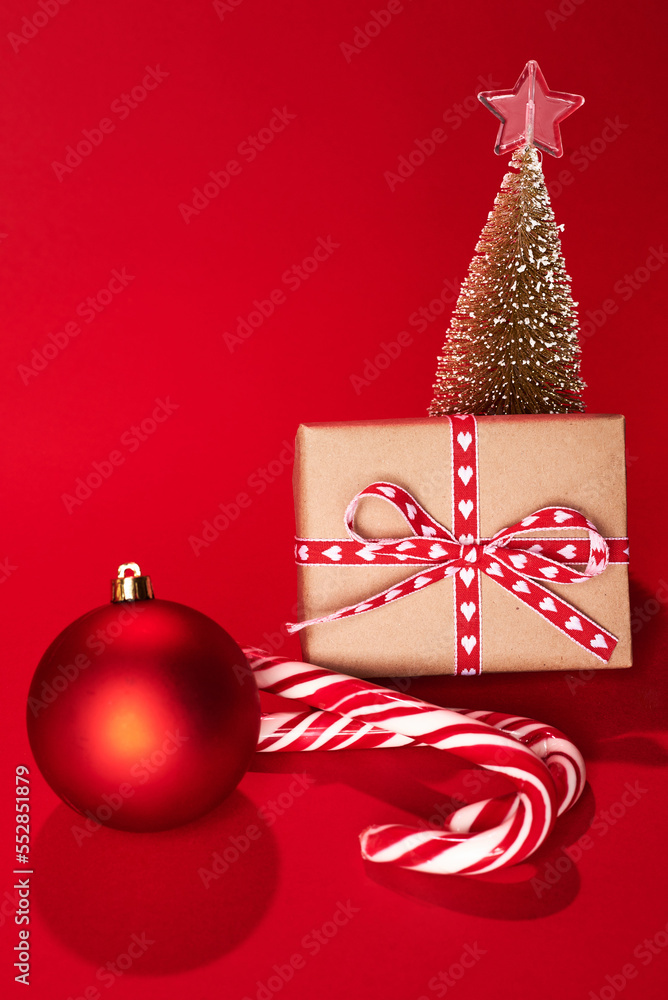 decorative Christmas trees and gift boxes on red background against red background