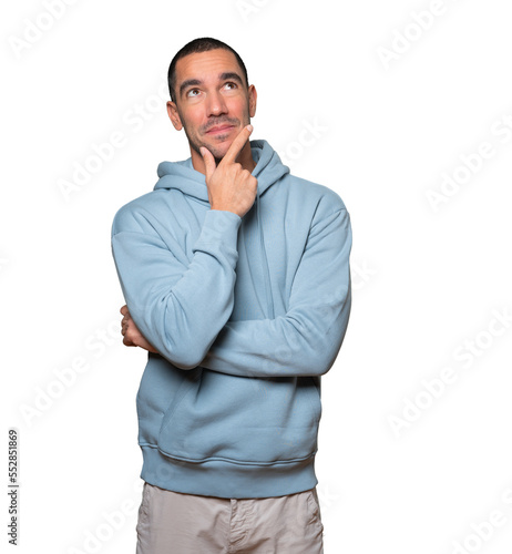 Happy young man making a gesture of doubt