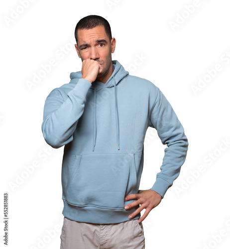 Angry young man posing against background