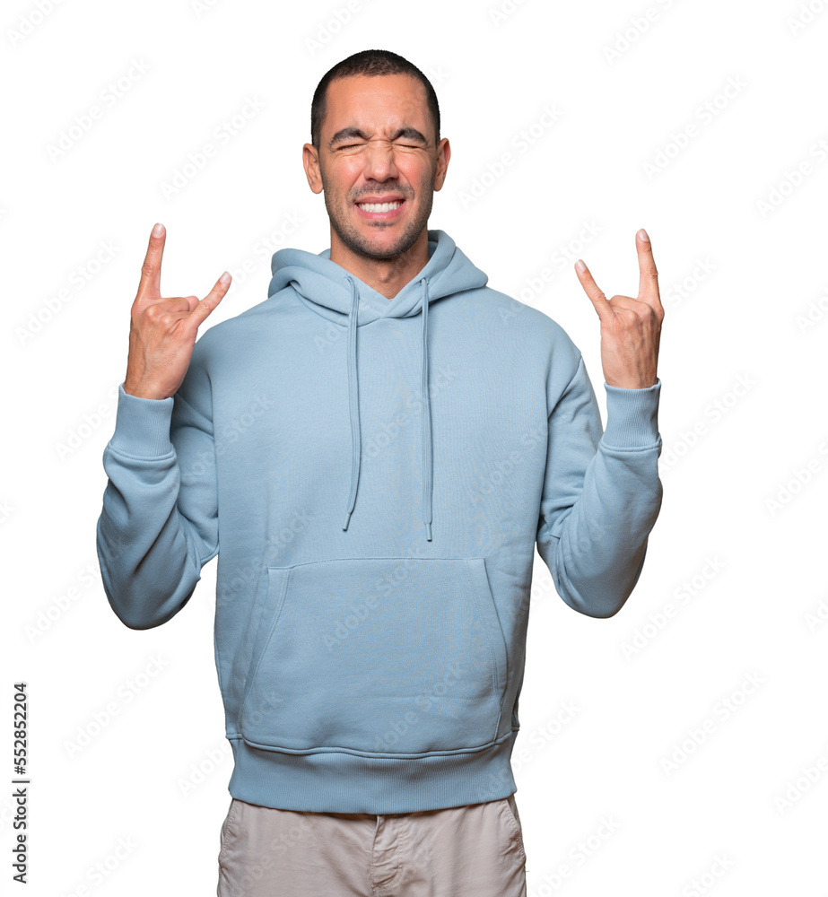 Fototapeta premium Naughty young man making a rock gesture