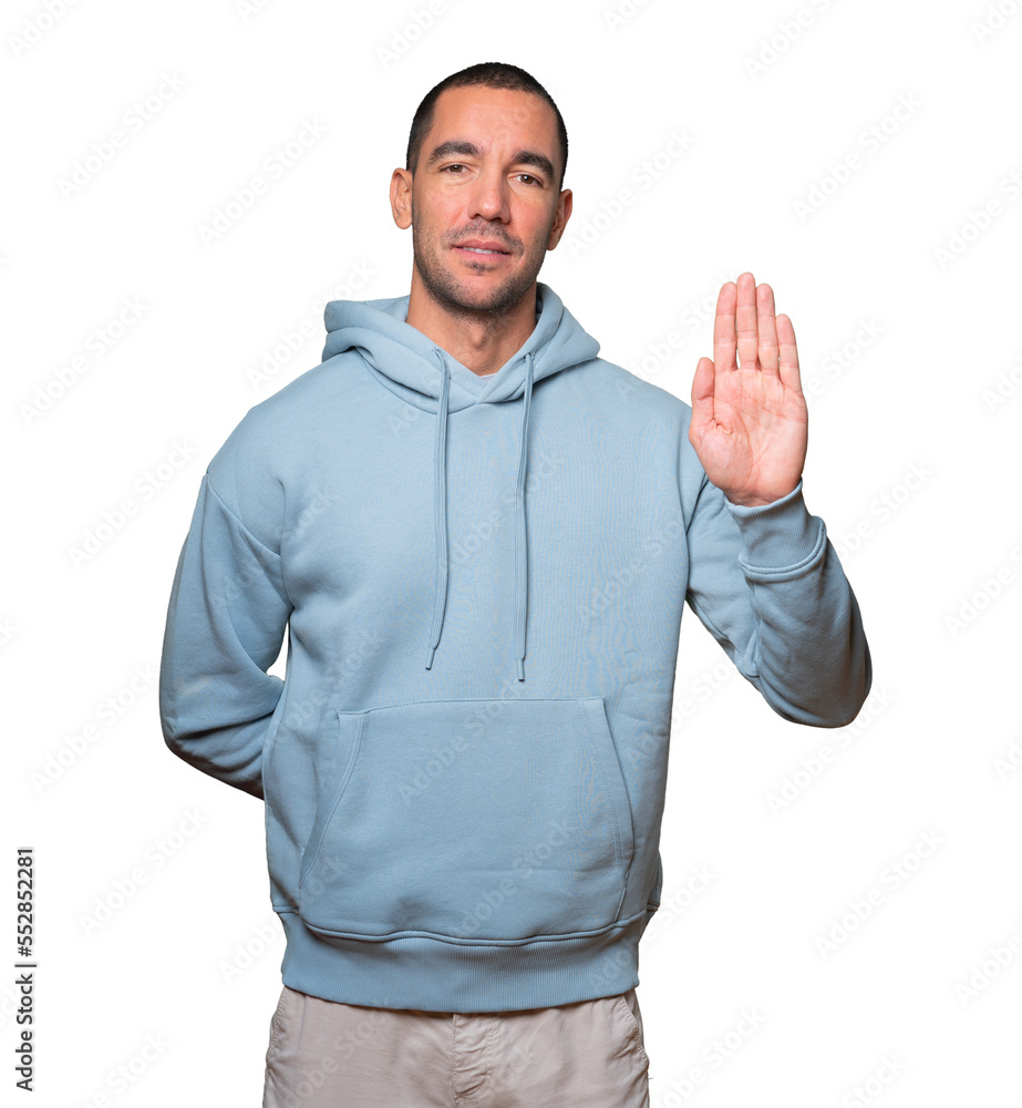 Happy young man making a gesture of stop with his palm Happy young man making a gesture of stop with his palm
