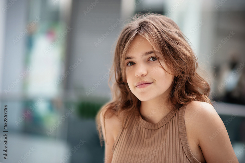 Portrait of beautiful teenage girl in shopping mall. Space for text