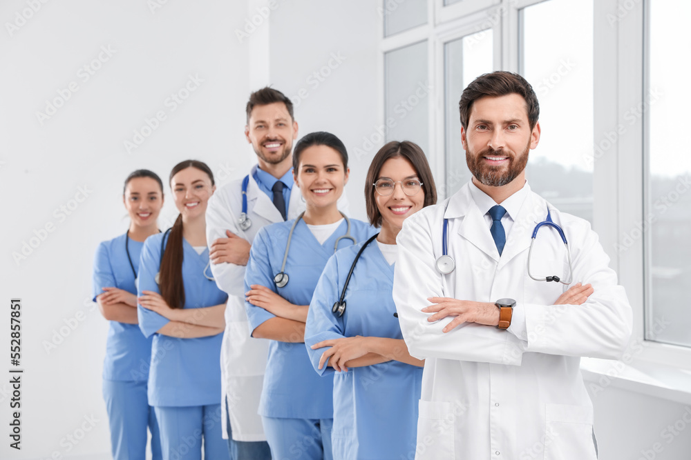 Team of professional doctors in clinic hallway Team of professional doctors in clinic hallway
