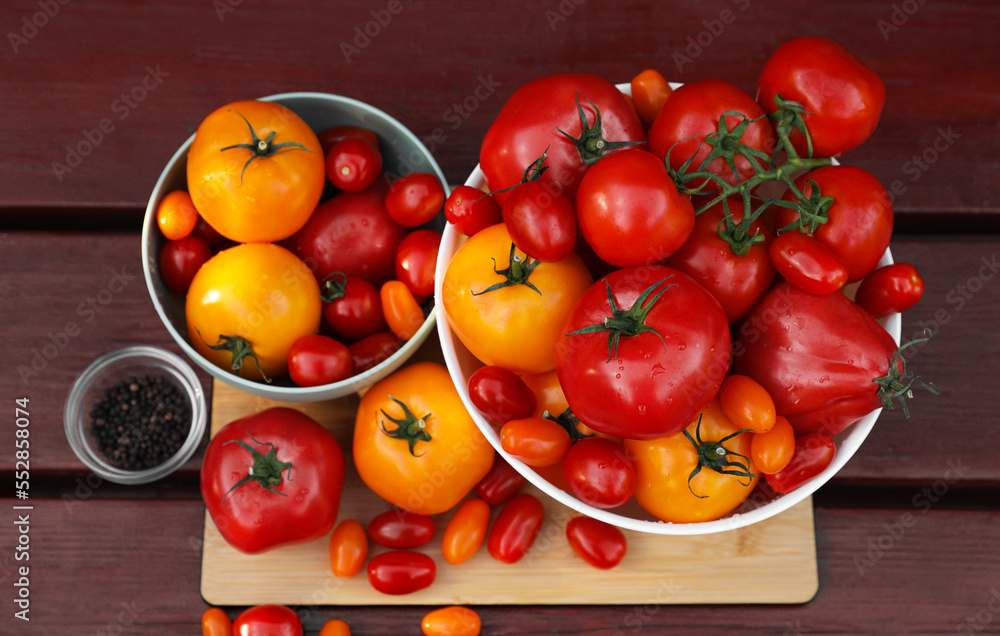 Bowls with fresh tomatoes and spices on wooden table, flat lay Bowls with fresh tomatoes and spices on wooden table, flat lay