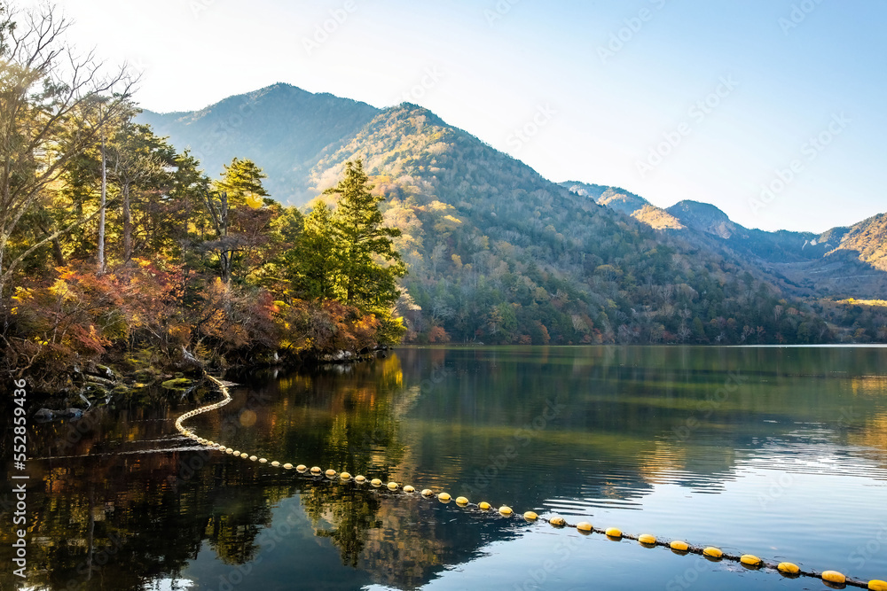 Scenic view of Yunoko lake at fall with colorful trees at sunset