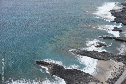 rocky lava coast on the tropical island of La Réunion, France on a stormy day by Cap La Houssaye