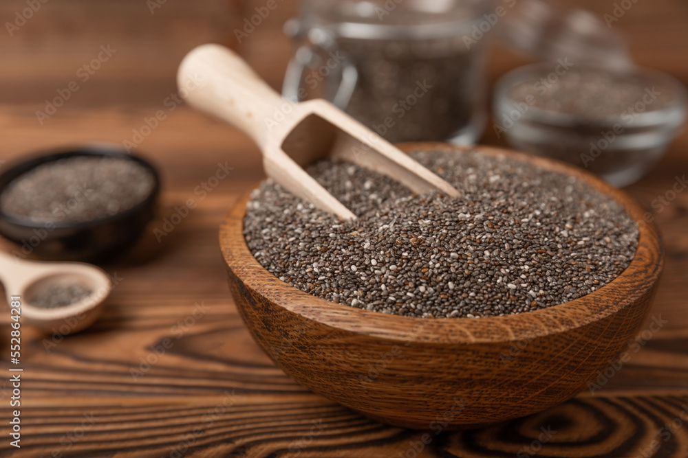 Chia seeds in a wooden spoon and bowl on a texture table. Superfood. Healthy food. Diet. The concept of proper nutrition. antioxidant. Place for text, space for copy. Chia seeds in a wooden spoon and bowl on a texture table. Superfood. Healthy food. Diet. The concept of proper nutrition. antioxidant. Place for text, space for copy.