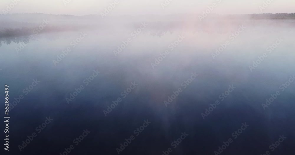 Sunrise in the misty forest, fog morning over the plain and lake floodplain in the meadow. Sunrise in a bog, wetland. Sunrise through fog. Calmness, relaxation, meditation, beauty of nature concept Sunrise in the misty forest, fog morning over the plain and lake floodplain in the meadow. Sunrise in a bog, wetland. Sunrise through fog. Calmness, relaxation, meditation, beauty of nature concept