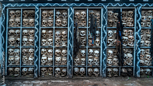 Full Frame Shot Of Human Skull And Bones Mounted On Wall At Tibet, China photo