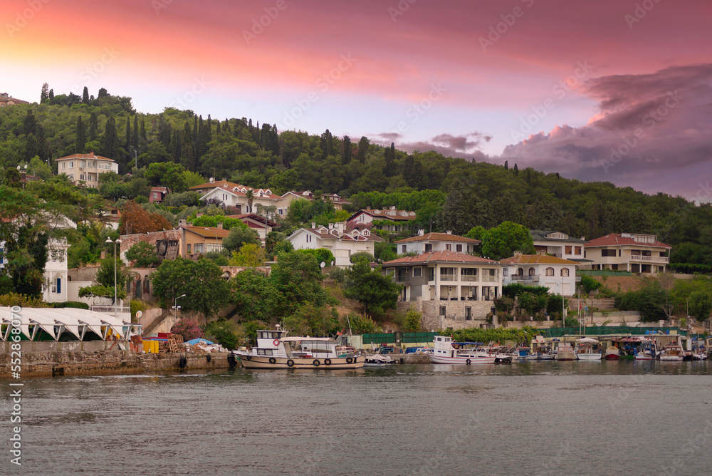 View of the mountains of Kinaliada island from Marmara Sea, with traditional summer houses and docked boats, at sunrise, Istanbul, Turkey View of the mountains of Kinaliada island from Marmara Sea, with traditional summer houses and docked boats, at sunrise, Istanbul, Turkey