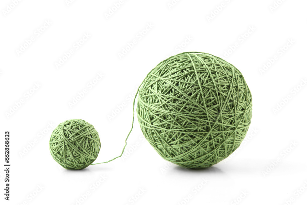 Two green thread balls big and small isolated on white background. Balls of natural cotton string. Two green thread balls big and small isolated on white background. Balls of natural cotton string.