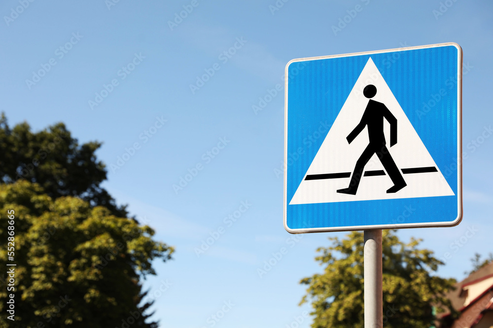 Pedestrian crossing road sign on city street. Space for text Pedestrian crossing road sign on city street. Space for text