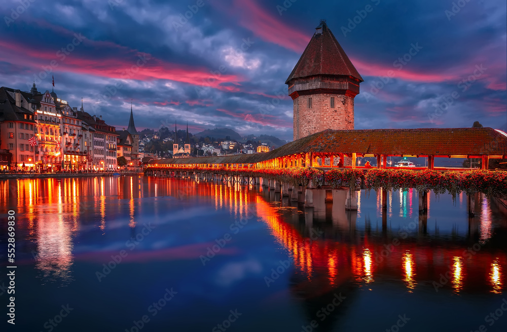 Colorful evening view of the Old Town medieval architecture in Lucerne, Switzerland. Dramatic scene with Reuss river, Chapel bridge. Wonderful vivid cityscape during sunset. popular travel destination