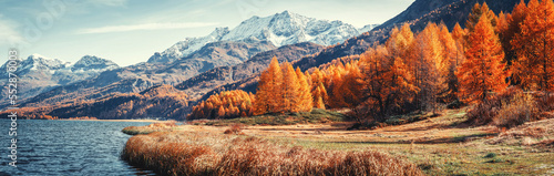 Amazing natural autumn scenery.  Panoramic view of beautiful mountain landscape in Alps with Lake Sils, concept of an ideal resting place. Lake Sils one of the most beautiful lake of the Swiss Alps photo