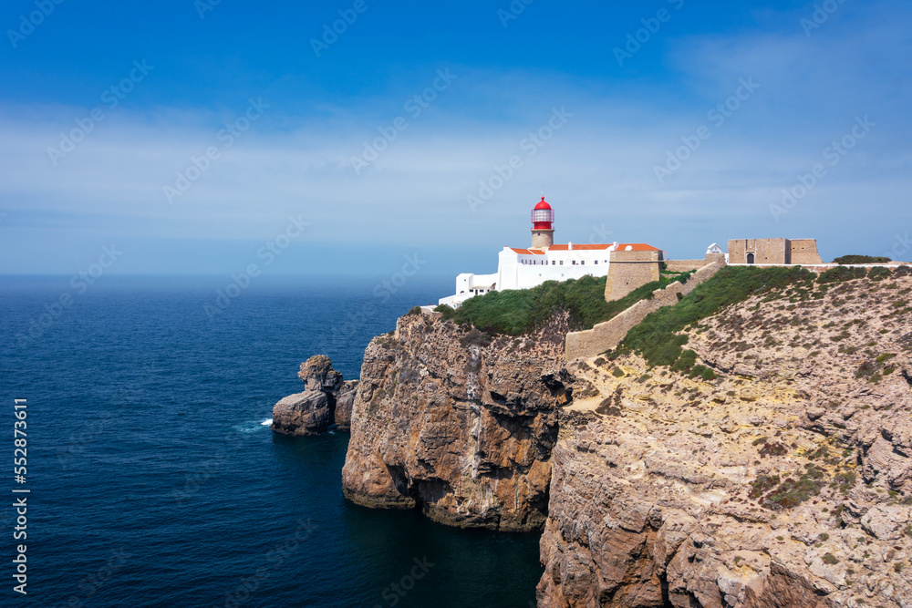 Lighthouse at Cabo San Vicente in Sagres Portugal. lighthouse with blue sky with clouds and sea