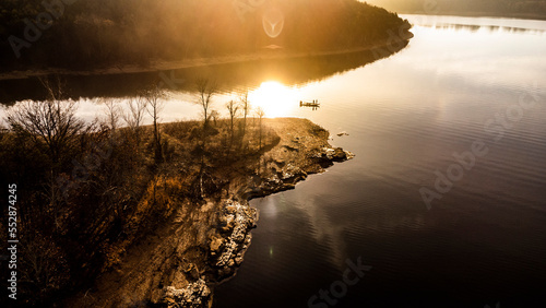 Bass fisherman fishing on table rock lake in missouri during sunrise in the winter