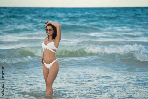 Female at Punta Cana beach posing in the white bikini