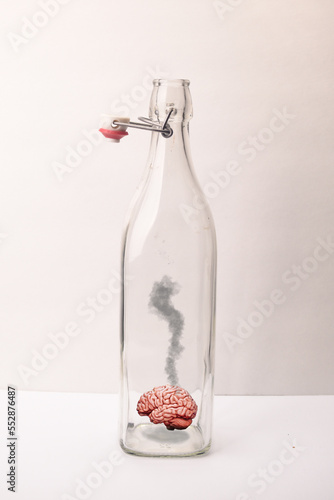 Photography smoking brain in clear bottle on white