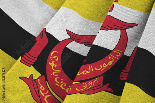 Brunei Darussalam flag with big folds waving close up under the studio light indoors. The official symbols and colors in fabric banner photo