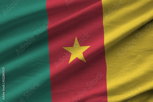 Cameroon flag with big folds waving close up under the studio light indoors. The official symbols and colors in fabric banner photo