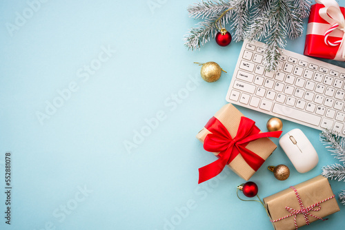 Oline shopping concept with presents and holiday decorations. Flat lay with copy space. photo