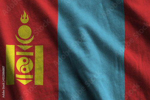 Mongolia flag with big folds waving close up under the studio light indoors. The official symbols and colors in fabric banner photo