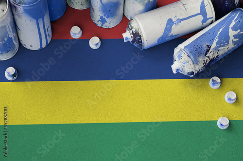 Mauritius flag and few used aerosol spray cans for graffiti painting. Street art culture concept, vandalism problems photo