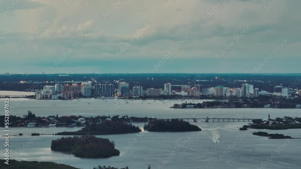Aerial view of american Sarasota city in Florida, USA at dusk. High skyscrapers and office buildings on horizon Aerial view of american Sarasota city in Florida, USA at dusk. High skyscrapers and office buildings on horizon