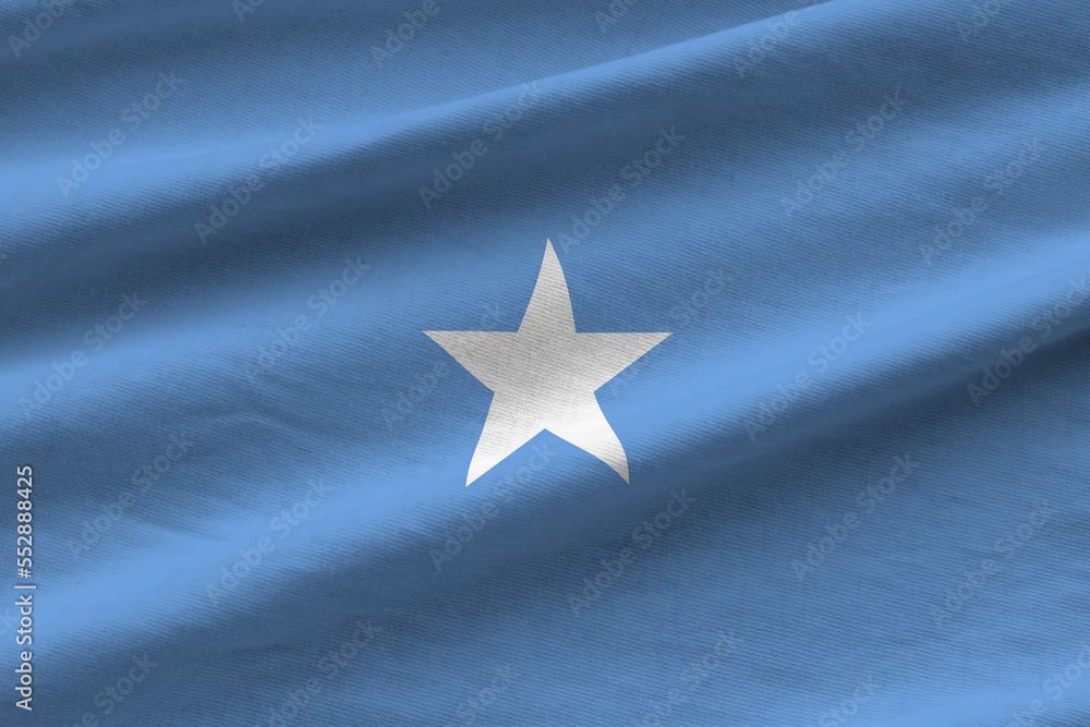 Somalia flag with big folds waving close up under the studio light ...