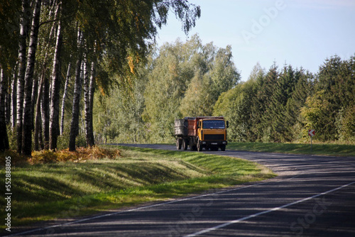 A sharp turn, a beautiful country road with a truck far