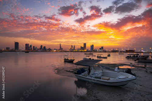 A beautiful panoramic view of Bahrain skyline with dramatic clouds after sunset.