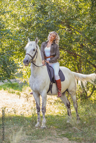 beautiful woman riding a white horse