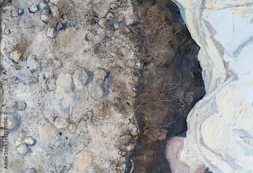 The girl lies in an earthen pit. A clothed woman with red hair. Oil painting portrait with biblical melancholic subject. Fragment of a painting with hands. photo