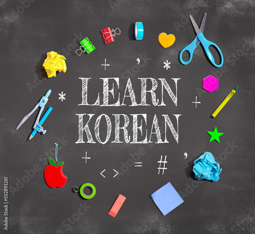 Learn Korean theme with school supplies on a chalkboard - flat lay