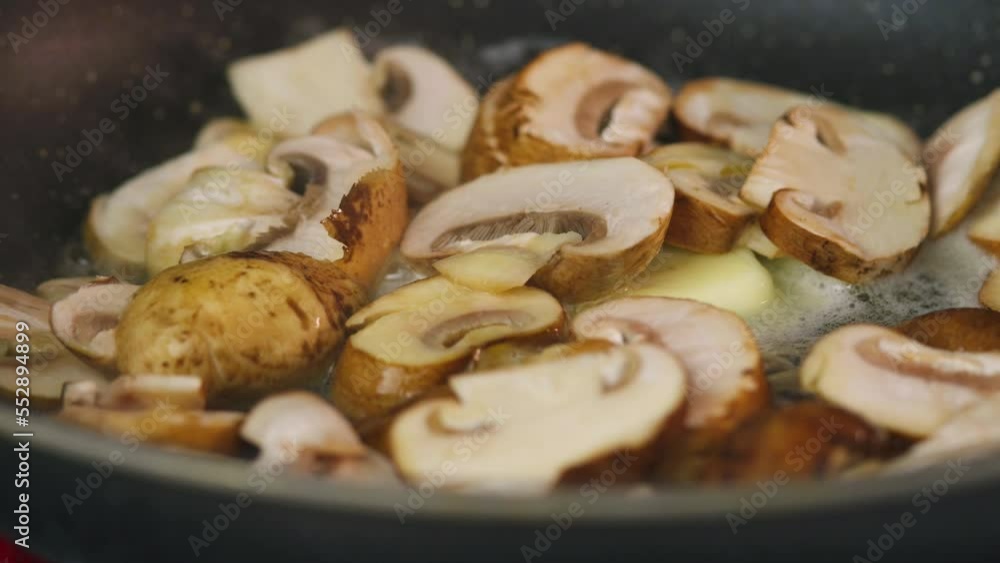 Video. Appetizing mushrooms are fried in a frying pan. Close-up. There are no people in the video. The concept is cooking, simple and delicious recipes for home and restaurant cuisine. Video. Appetizing mushrooms are fried in a frying pan. Close-up. There are no people in the video. The concept is cooking, simple and delicious recipes for home and restaurant cuisine.