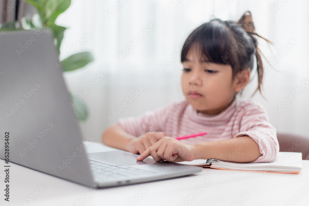 Asian little girl at home doing homework Asian little girl at home doing homework